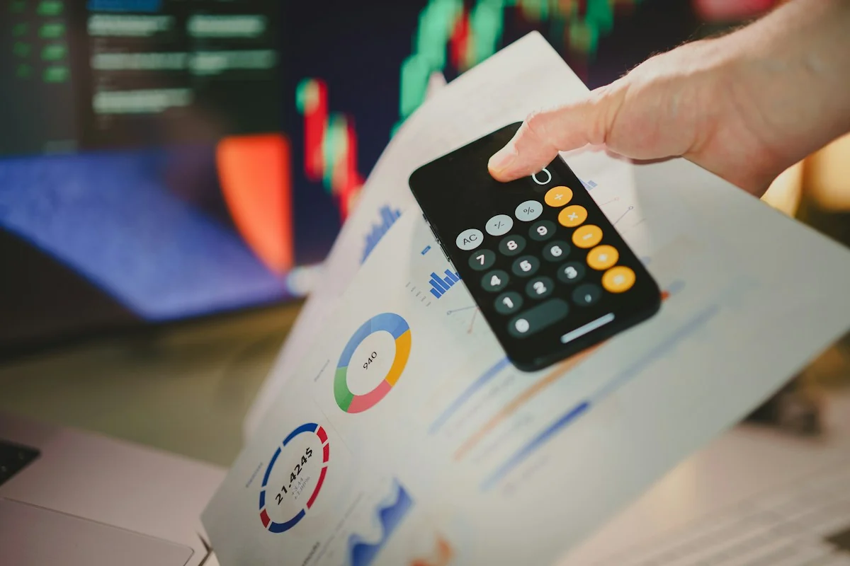 Calculator held over paperwork